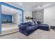 Inviting living room featuring a comfortable blue sectional, stone accent wall, and neutral carpeting at 7925 York St # 2, Denver, CO 80229