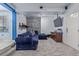 Cozy living room boasts stone accent wall, plush blue sectional, and a carpeted floor at 7925 York St # 2, Denver, CO 80229