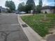 Street view of a residential area with parked cars and green spaces at 7925 York St # 2, Denver, CO 80229