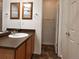 Bathroom featuring a vanity with a sink, mirror, and fixtures, as well as an open closet space at 20768 Randolph, Denver, CO 80249