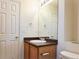 Bathroom featuring a vanity with a sink, mirror, and fixtures with a toilet in view at 20768 Randolph, Denver, CO 80249