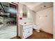 This bathroom features a functional toilet, a vanity with a mirror, carpet and access to the basement at 678 S Oswego Ct, Aurora, CO 80012