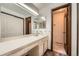 Bathroom with vanity, large mirror, and a separate toilet room at 678 S Oswego Ct, Aurora, CO 80012