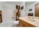 This bathroom offers a bathtub, shower with curtain, toilet and vanity with mirror at 678 S Oswego Ct, Aurora, CO 80012