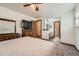 Bedroom leading into en-suite bathroom with carpet and ceiling fan at 678 S Oswego Ct, Aurora, CO 80012