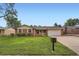 Charming brick home featuring a well-manicured lawn and an attached two-car garage at 678 S Oswego Ct, Aurora, CO 80012