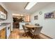Eat-in kitchen features a round table, hardwood floors, and white appliances at 678 S Oswego Ct, Aurora, CO 80012