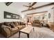 Living room features exposed wood beams, neutral carpet, and a brick fireplace view at 678 S Oswego Ct, Aurora, CO 80012