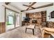 Living room features a brick fireplace, ceiling fan, and sliding glass doors at 678 S Oswego Ct, Aurora, CO 80012