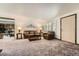 Cozy living room with neutral carpet, plantation shutters and comfortable seating arrangement at 678 S Oswego Ct, Aurora, CO 80012
