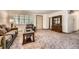 Inviting living room featuring neutral carpet, shuttered windows, and a decorative hutch at 678 S Oswego Ct, Aurora, CO 80012