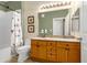 Bathroom featuring a double vanity, toilet, and a shower with a butterfly curtain at 9390 W Chatfield Pl # 104, Littleton, CO 80128