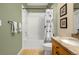 Bathroom featuring a tiled shower/tub, vanity, and towel rack at 9390 W Chatfield Pl # 104, Littleton, CO 80128