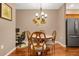 Cozy dining area featuring a round table, four chairs, decorative lighting, and adjacent workspace at 9390 W Chatfield Pl # 104, Littleton, CO 80128