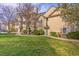 Exterior shot of a condo complex with green landscaping and sidewalks for easy access to units at 9390 W Chatfield Pl # 104, Littleton, CO 80128