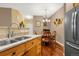 Kitchen with updated stainless steel appliances, granite countertops, and a view into the dining room at 9390 W Chatfield Pl # 104, Littleton, CO 80128