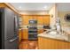 Updated kitchen with stainless steel appliances, granite countertops, and wood cabinets for ample storage at 9390 W Chatfield Pl # 104, Littleton, CO 80128