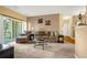 Bright living room with a sliding glass door, comfortable seating, and a well-lit atmosphere at 9390 W Chatfield Pl # 104, Littleton, CO 80128