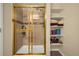 Tiled shower with glass door and built-in shelves at 9390 W Chatfield Pl # 104, Littleton, CO 80128