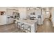Bright kitchen with granite island, stainless steel appliances, and modern gray cabinets at 1885 Mount Monroe Dr, Berthoud, CO 80513