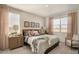 Serene main bedroom featuring neutral tones, plush bedding, and ample natural light at 1885 Mount Monroe Dr, Berthoud, CO 80513