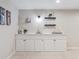 Basement bar area with open shelving, white cabinets and speckled countertop at 6953 S Prescott St, Littleton, CO 80120
