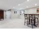 Finished basement with bar, white cabinets and shelving, light gray carpet and recessed lighting at 6953 S Prescott St, Littleton, CO 80120