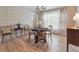 Bright dining area featuring a round table, wood floors, and natural light at 6953 S Prescott St, Littleton, CO 80120