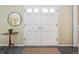 Bright entryway with a double door entry, tile flooring, and a decorative table at 6953 S Prescott St, Littleton, CO 80120