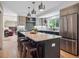 Lovely eat-in kitchen with central island, stainless fridge, modern lighting and hardwood floors at 6953 S Prescott St, Littleton, CO 80120