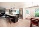 Modern kitchen with a spacious island, stainless steel appliances, and a dining area at 6953 S Prescott St, Littleton, CO 80120