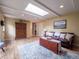 Spacious living room with hardwood floors, a skylight, and cozy seating at 6953 S Prescott St, Littleton, CO 80120