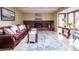 Comfortable living room featuring a brick fireplace and large area rug at 6953 S Prescott St, Littleton, CO 80120