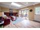 Bright living room with brick fireplace, skylight, and cozy seating area at 6953 S Prescott St, Littleton, CO 80120