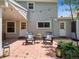 Cozy backyard patio with brick pavers, outdoor seating, string lights, and decorative plants at 6953 S Prescott St, Littleton, CO 80120