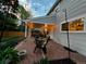 Backyard patio with brick pavers, outdoor seating and string lights at 6953 S Prescott St, Littleton, CO 80120