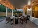 Covered backyard patio with outdoor furniture, brick pavers, and string lights at 6953 S Prescott St, Littleton, CO 80120