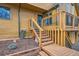 View of the home's wooden deck with stairs leading down to a lower level with wood siding at 643 Aspen Rd, Golden, CO 80401