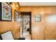 Wood paneled hallway view showing access to bedroom with wood floors and neutral walls at 9309 Highland Pl, Arvada, CO 80002
