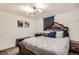Bedroom with a statement headboard, soft gray linens, and curated artwork on the walls at 9309 Highland Pl, Arvada, CO 80002