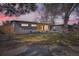 Charming single-story home at dusk with a well-maintained lawn, modern design, and attached garage at 9309 Highland Pl, Arvada, CO 80002