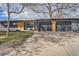 Stylish single-story home featuring an attached two-car garage and modern wood detailing at 9309 Highland Pl, Arvada, CO 80002