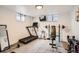 Home gym equipped with treadmill, weight machines, and mirror at 9309 Highland Pl, Arvada, CO 80002