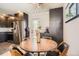 Eat-in kitchen area with gray cabinetry, stainless steel refrigerator, and contemporary light fixture at 9309 Highland Pl, Arvada, CO 80002