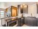 Elegant kitchen with dark wood cabinets, granite countertops, and stainless steel appliances at 9309 Highland Pl, Arvada, CO 80002