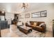 Inviting living room featuring hardwood floors, a comfortable leather sofa, and stylish decor at 9309 Highland Pl, Arvada, CO 80002