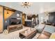 Open-concept living area with a modern TV setup, stylish decor, and easy access to the kitchen at 9309 Highland Pl, Arvada, CO 80002