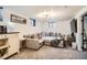 Comfortable living room area with a large sectional sofa and modern lighting at 9309 Highland Pl, Arvada, CO 80002