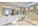 Beautiful bathroom with a spacious walk-in shower, double sinks, and modern fixtures at 8576 Hotchkiss St, Littleton, CO 80125
