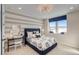 Charming bedroom with a cozy window seat, stylish lighting, and a serene view of the snow-covered landscape at 8576 Hotchkiss St, Littleton, CO 80125